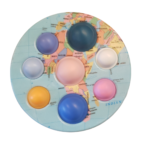 7 inch disc with varied size poppers of different colors with backdrop of map of countries